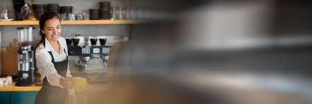 Blurred effect with copy space against caucasian waitress serving coffee at a cafe. business concept