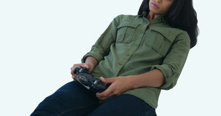 African american woman with controller playing videogames against copy space on white background....