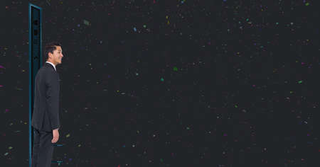 Asian businessman standing against white spots and copy space on black background. global business and modern technology conceptの写真素材