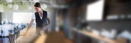 Blurred effect with copy space against caucasian waitress cleaning a table at a restaurant....