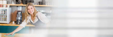 Blurred effect with copy space against caucasian waitress cleaning a table at a restaurant. restaurant business conceptの写真素材