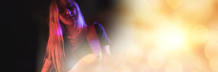 Blurred effect with copy space against mid section of caucasian female artist playing guitar. music festival and concert conceptの写真素材