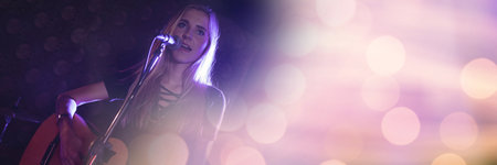 Spots of light with copy space against caucasian female artist playing guitar and singing. music...