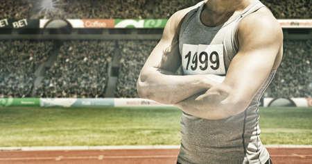 Spots of light against mid section of male athlete with arms crossed against sports stadium. sports,...