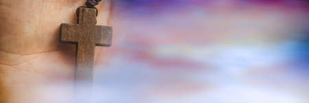 Blur effect with copy space against close up of a hand holding a rosary. christianity and religion...