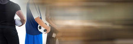 Blur effect with copy space against mid section of soccer player and rugby player. sports and fitness conceptの写真素材
