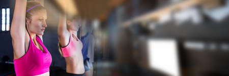 Blur effect with copy space against caucasian fit woman performing pull up exercise at the gym....