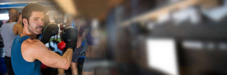 Blur effect with copy space against portrait of caucasian male boxer at the gym. sports and fitness...