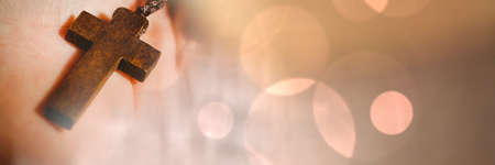 Blur effect with copy space against close up of a hand holding a rosary. christianity and religion conceptの写真素材