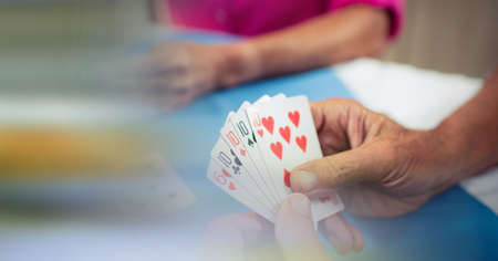Blur effect with copy space against mid section of senior people playing cards. retirement home and entertainment conceptの写真素材