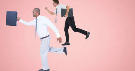 African american and caucasian businessmen walking against with copy space on pink background. business conceptの写真素材