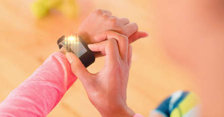 Light spot against close up of person using a smartwatch. sports, competition and technology concept