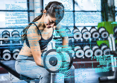 Composite image of data processing against asian fit woman working out at the gym. sports fitness and technology conceptの写真素材