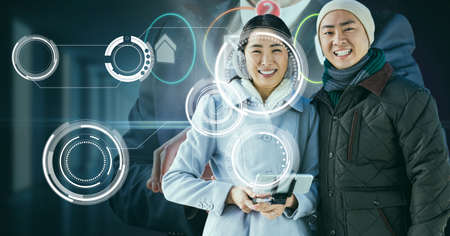 Multiple round scanners over portrait of asian couple smiling against businessman using smartphone....