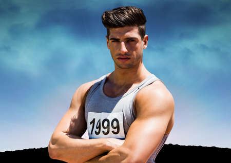 Portrait of caucasian male athlete against blue sky in background with copy space. sports and competition conceptの写真素材