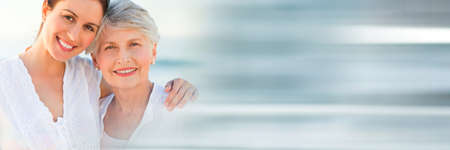 Blurred effect with copy space against portrait of caucasian mother and daughter smiling. motherhood and love conceptの写真素材