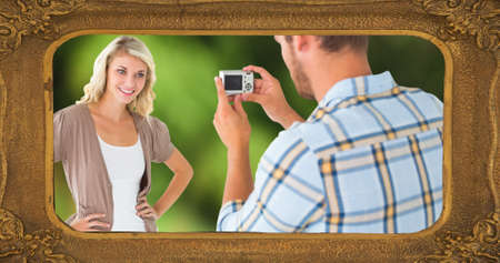 Composite of picture frame and caucasian man photographing smiling young woman with digital camera. national photography day, photographer, technology, art and celebration concept.の写真素材