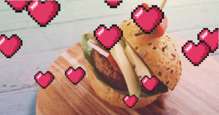 Image of hearts floating over burger on wooden board. american cuisine and fast food concept digitally generated image.の写真素材