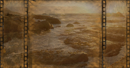 Old Movie tape showing ocean with stones in the sun
