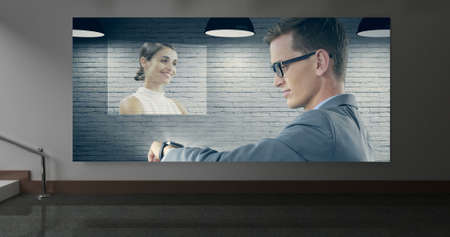 Digital composite of businesspeople interacting on mock up against animated grey wall