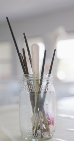 Vertical image of empty white painting classroom with painting equipment and easel. school and education.の写真素材