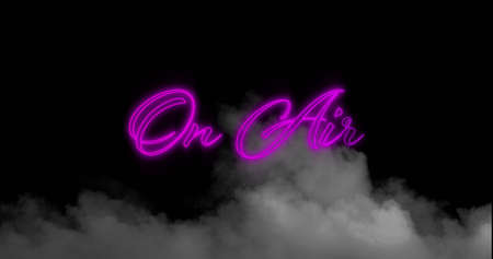Digital image of neon purple on air text sign over smoke effect against black background. radio and transmission conceptの写真素材