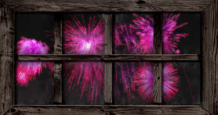 Image of window with pink christmas and new year fireworks in night sky. christmas, new year,...