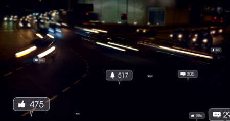Image of social media icons and numbers over out of focus traffic lights. global social media,...