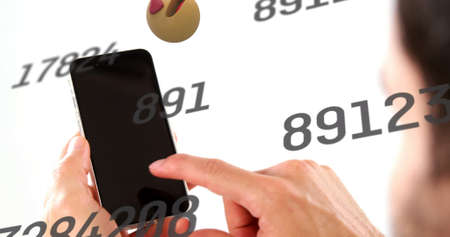 Image of social media icons and numbers falling over woman using smartphone. global social media, networking and communication concept digitally generated image.の写真素材