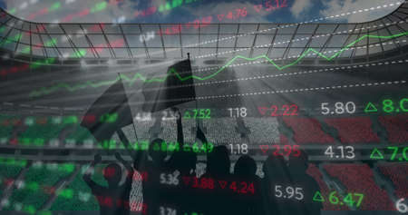 Stock market data processing against silhouette of fans cheering and sports stadium in background. sports competition and tournament conceptの写真素材