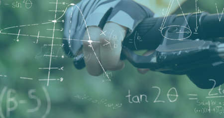 Image of handwritten mathematical equations recording over woman cycling in the forest holding...