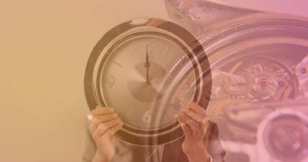 Image of clock over hands holding clock. global business and digital interface concept digitally generated image.の写真素材