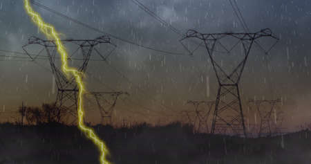 Image of heavy rain, storm with yellow lightning and grey clouds over electric pylons. sustainability and climate change concept digitally generated image.の写真素材