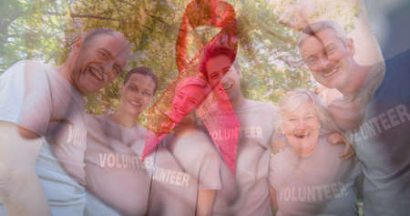 Multiple image of portrait of happy caucasian volunteers against tree and red awareness ribbon....