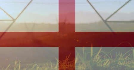 Image of flag of england over pylons. ukraine crisis and international politics concept digitally generated image.の写真素材