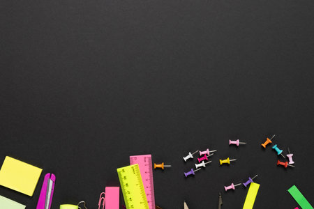 Imagine of various office supplies, pins, rulers, scissorson on black background. Education, learning and creativity.の写真素材