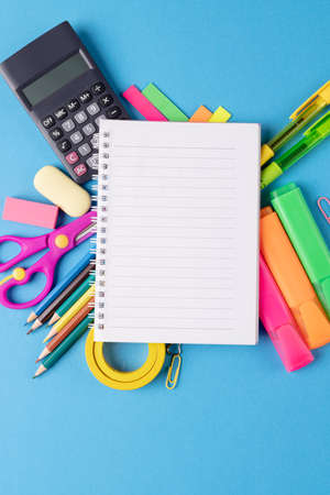 Image of various office supplies, pens and notebook on blue background. Education, learning and creativity.の写真素材