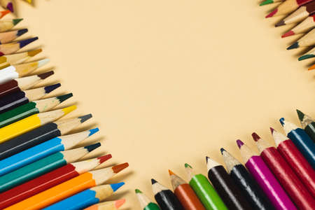 Composition of colorful crayons on beige surface with copy space. School equipment, drawing tools, pattern and creativity concept.の写真素材