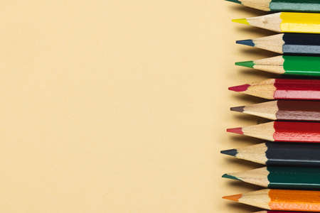 Composition of colorful crayons on beige surface with copy space. School equipment, drawing tools, pattern and creativity concept.の写真素材
