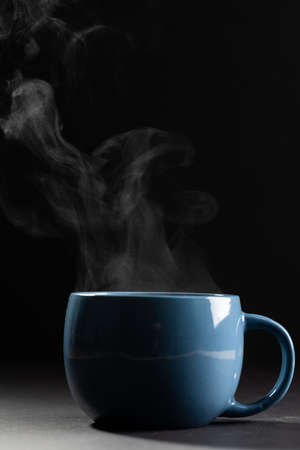 Image of blue cup of hot black coffee on black background. Coffee, refreshment and beverages.の写真素材