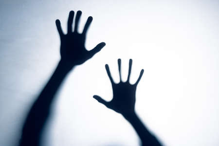 Composition of shape of two black hands on white background. Halloween tradition and celebration concept.の写真素材