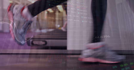 Image of graphs over legs of caucasian woman exercising at treadmill. Sporty, active lifestyle, staying in shape concept digitally generated image.の写真素材