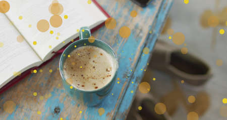 Image of falling yellow dots over coffee. Global business, finances, data processing and digital...