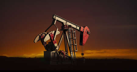 Image of oil pump working over sunset and landscape in background. Oil industry and oil pump concept...