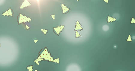 Image of christmas trees over lights and green background. Christmas, winter and tradition concept digitally generated image.の写真素材