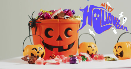 Happy halloween text banner and ghosts icons against pumpkin shaped bucket full of halloween candies. halloween festivity and celebration conceptの写真素材