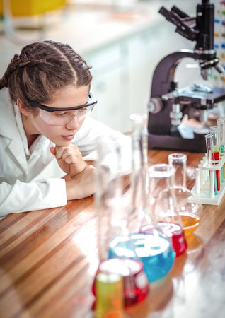 Scientist looking at chemical solution in laboratory