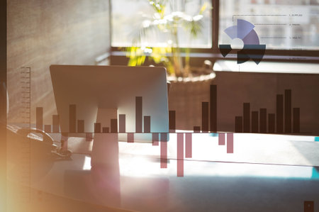 Double exposure of graphs and desk in officeの写真素材