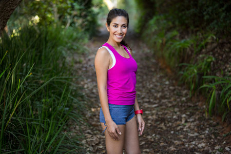Smiling fit woman standing on field