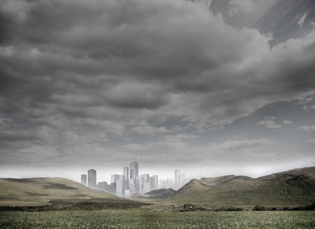 Digitally generated cityscape in distance under cloudy skyの写真素材